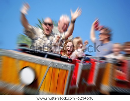 Father and Daughter On Amusement Park Roller Coaster with Zoom Blur