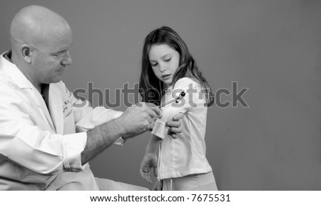 Physician Examining Girl\'s Reflexes