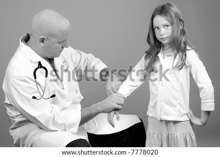 Physician Taking Girls Pulse During Physical Exam