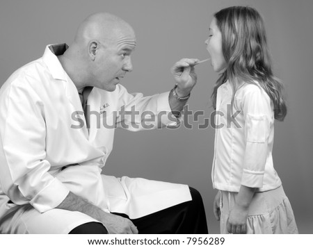 Physician Examining Young Girl\'s Throat