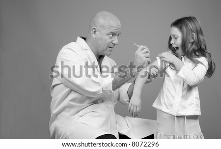 Physician Administering Shot to Child