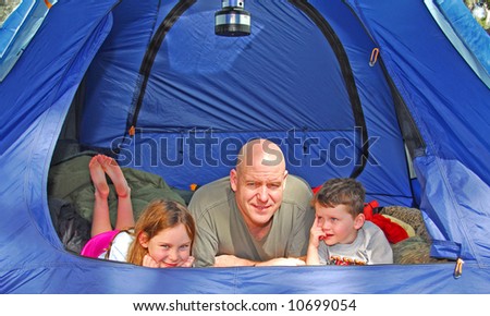 Father and young children in camping in dome tent