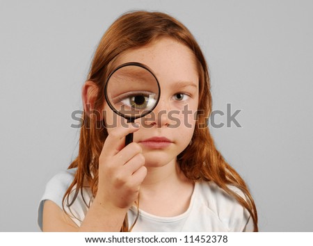 Looking Through Glass. Young girl looking through