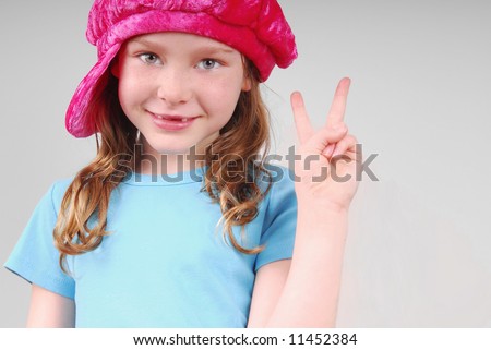 stock photo Cute young girl with missing front teeth wearing cap and 