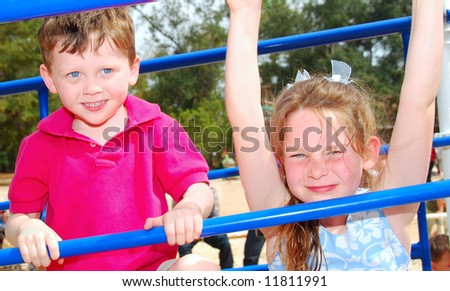 Cute boy and girl on playground outside
