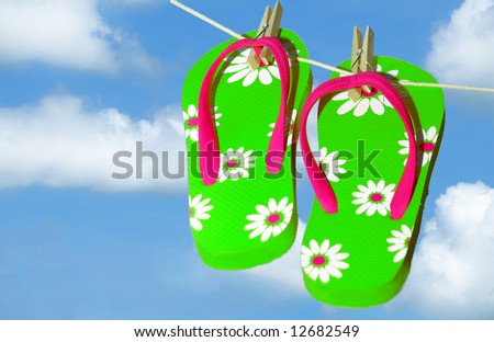 stock photo : Pretty green and pink flip flop sandals on clothes line under pretty sky