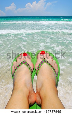 Feet in Flip Flop Sandals at Seashore