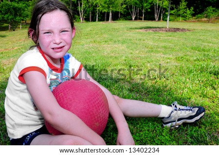stock photo Young girl holding ball looking hot sweaty and tired after 