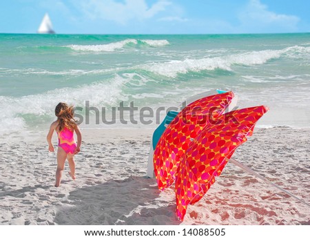 Girl running by umbrellas with Sailboat in distance with surf at pretty beach