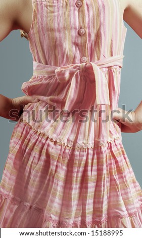 Back buttons and bow of pretty sundress on young girl