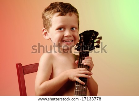Young boy playing around with guitar on stage