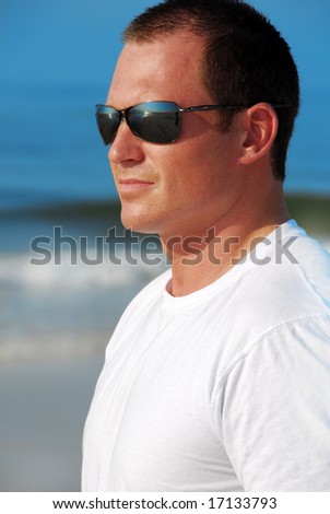 Handsome man wearing sunglasses on beach