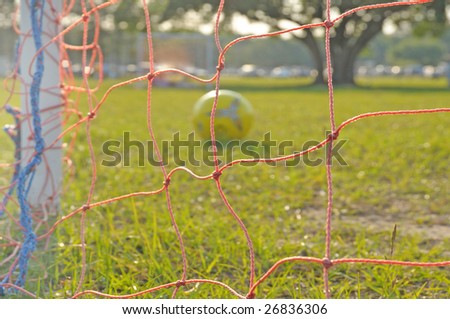 soccer ball left on deserted playing field after game ended