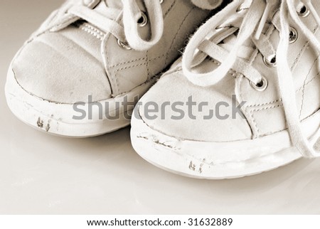 pair of dirty and scuffed up tennis shoes