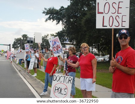 PENSACOLA, FLORIDA - SEPTEMBER 7: Concerned citizens protest Healthcare Reform while standing along Davis Highway on September 7, 2009 in Pensacola, Florida.