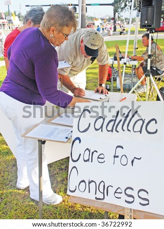 PENSACOLA, FLORIDA - SEPTEMBER 7: Concerned citizens sign a petition at a protest rally regarding Healthcare Reform along Davis Highway on September 7, 2009 in Pensacola, Florida.
