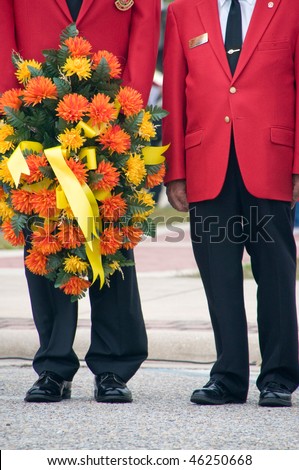 Marine corps war veterans holding ceremonial wreath