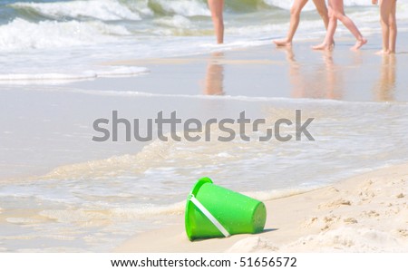 Sand pail on beach by children