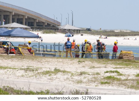 GULF SHORES - MAY 8: Workers gather on May 8, 2010 to protect beautiful Gulf Shores, Alabama from the BP oil spill that threatens the popular resort area.