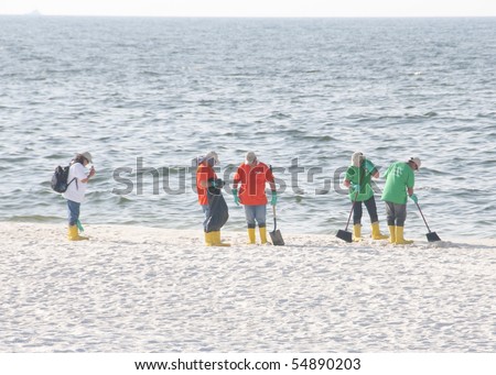 PERDIDO KEY, FL - JUNE 9: BP oil spill workers clean the beaches on June 9, 2010 as oil threatens the pristine Gulf Shores National seashore near Pensacola, FL.