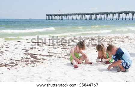 PENSACOLA BEACH - 23 JUNE: Unidentified young children play with sand near oil patches on June 23, 2010 in Pensacola Beach, FL.