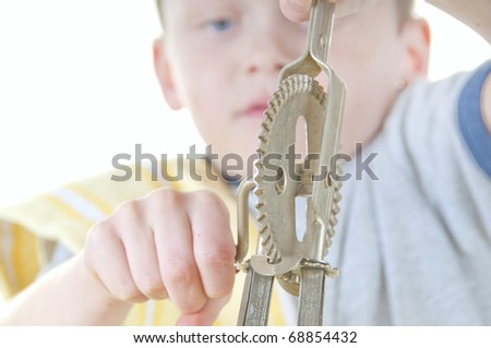 Young boy using vintage hand mixer to cook