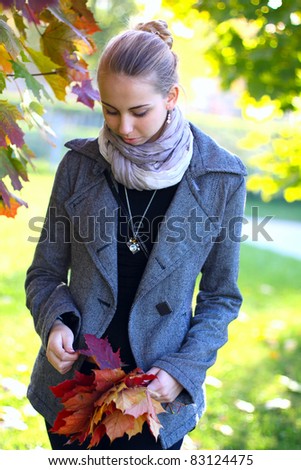 college girl in park with yellow leaves