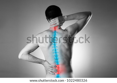 Pain in the spine, a man with backache, injury in the human back and neck, black and white photo with highlighted skeleton