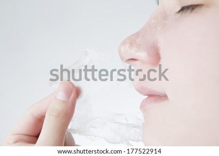 Facial mask. Skin Care. Head of a young woman closeup. Isolated on white background.