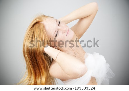 Portrait of a beautiful young woman on a gray background. Hair Care. Caring for the skin