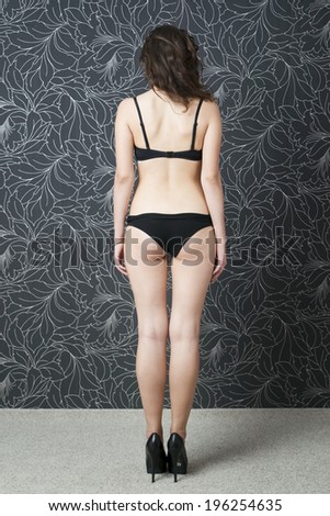 Beautiful young woman in underwear. Slender figure.