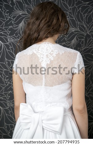 Beautiful woman in white wedding dress.  Back view