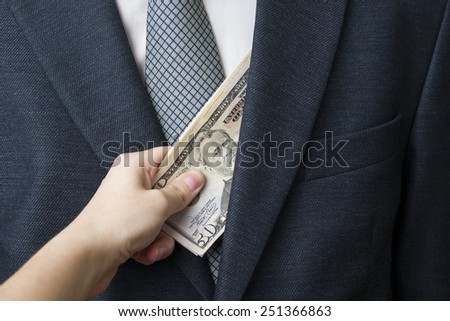 Concept - corruption. Giving a bribe. Money in hand