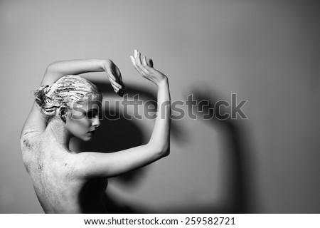 Portrait of the beautiful naked woman. Black and white photography. Body care. Spa. Mask of clay