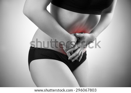 Woman with abdominal pain. Pain in the  human body. Black and white photo with red dot