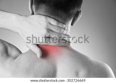 Pain in the neck. Man with backache. Pain in the man\'s body on a gray background