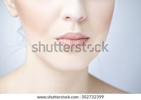 Professional beauty eyes makeup. Make up closeup. Plump sexy lips and perfect skin on a gray background