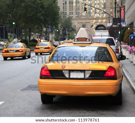 NEW YORK - AUG 24: Busy yellow taxis in traffic.  The taxicabs, with their distinctive yellow paint, are a widely recognized icon of the city on August 24, 2012 in New York, USA.