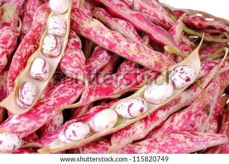 purple beans and pods in a straw basket