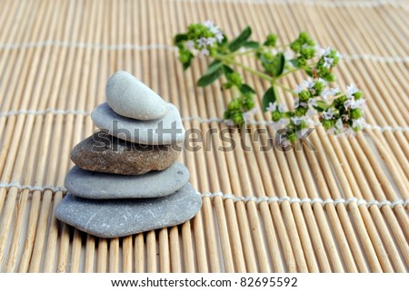 zen stones on bamboo background. concept of meditation, harmony, relax and wellness