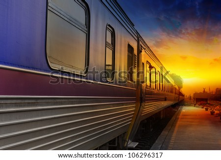 Train passing by in orange sunset