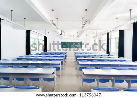Bright empty classroom with desks and chairs