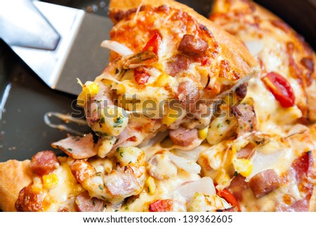 Slices of pizza stack on pan