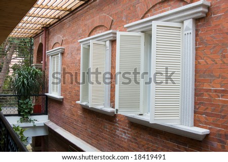 Several old style white wooden shutters in a villa