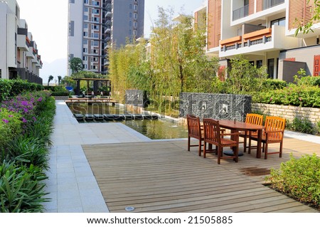 Outdoors landscape with resting chairs and fountain and tree in a new residential district