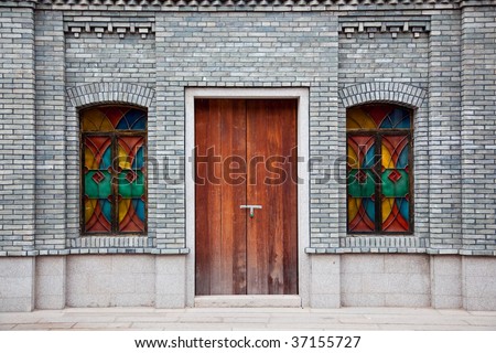 Detail of old Chinese style building facade with arch doors and colorful windows in a town.This is architectural style in the begin of last century\'s.