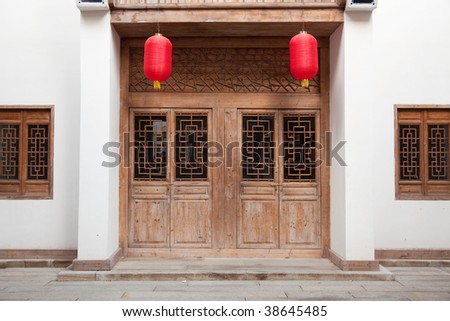 Detail of old Chinese style building facade with wooden door and  windows in a town.This is architectural style in the begin of last century\'s.