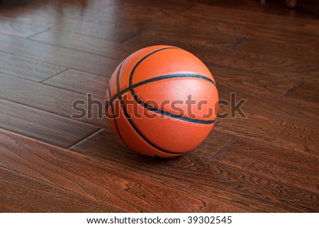 Basketball on the hardwood basketball floor in a stadium