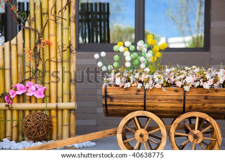 Street scene with flower cart and beautiful reflection of blue sky on window.