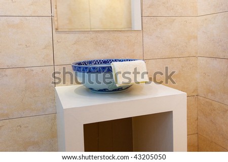 Decorated and tiled bathroom with  blue and white porcelain sink in a new bathroom